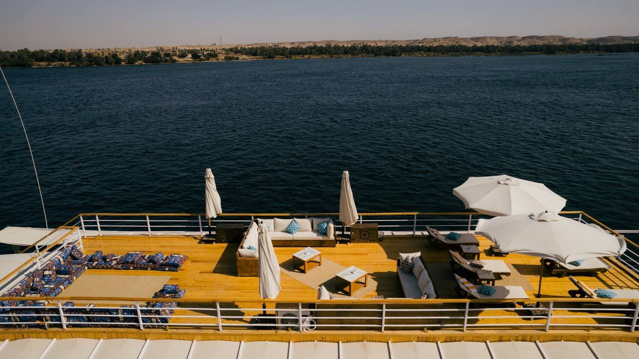 Expansive 70m² Sky Roof terrace on Soul of the Nile Dahabiya featuring sun loungers and panoramic Nile views