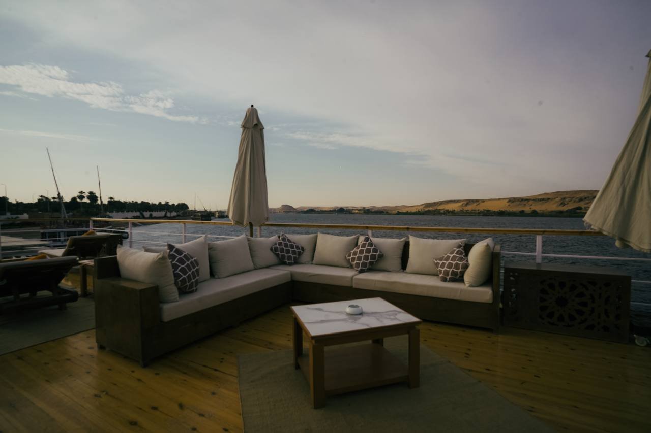 Relaxing sunset lounge area on the deck of Soul of the Nile Dahabiya featuring comfortable corner seating and river views